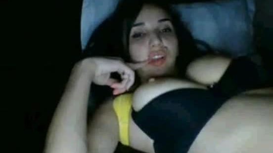Brunette girl masturbates on the bed